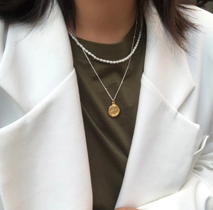 Double-layered 925 silver necklace with small white pearls and a gold coin pendant