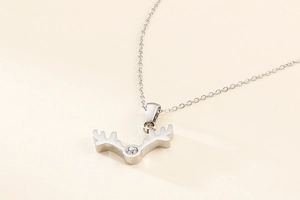 Detail of silver reindeer antler necklace featuring a sparkling crystal stone accent