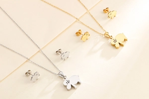 Detailed view of cute pig pendant necklace and earring set in gold and silver finish
