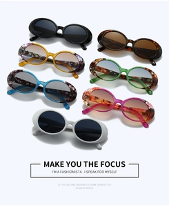 Flat lay view showing seven stylish vintage oval sunglasses in diverse multi-colored frames