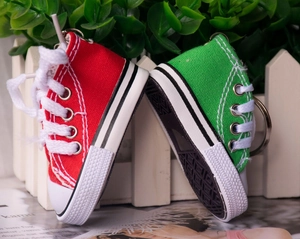 Macro shot of mini canvas sneaker keychains showing detailed rubber soles and stitching