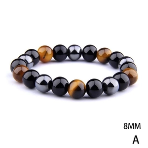 Macro detail of 8mm tiger eye, obsidian and hematite beads on a stretch bracelet