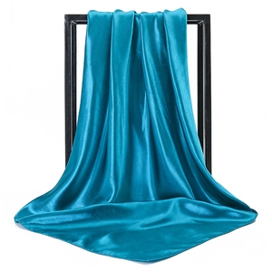 Detailed view of peacock blue satin silk square scarf with elegant draped texture