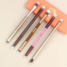 Detail of 5 double-ended makeup brushes with multicolor handles and dual-tone bristles