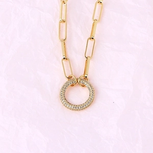 Detail of gold-plated paperclip chain necklace featuring a micro-pave zircon round link