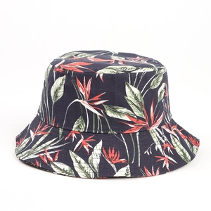 Close-up of black cotton bucket hat featuring colorful tropical leaf patterns and textures