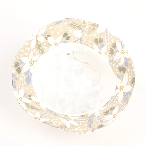 Detail of 100% cotton floral sun hat interior with leaf print and white care label