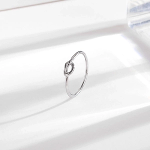 Minimalist silver knot ring in high-polished titanium steel with modern shadow effect