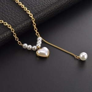 Titanium steel heart pearl necklace with tassel pendant on elegant black texture