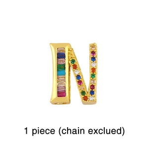 Detailed close-up of a golden N-letter charm inlaid with multicolored zircon stones