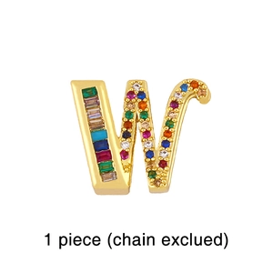 Detailed macro view of a gold letter W pendant featuring vibrant rainbow crystal stones