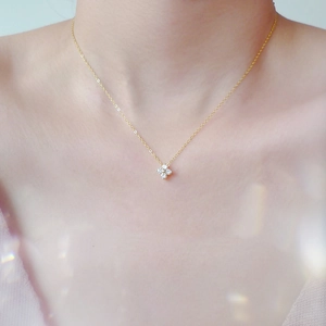 Sparkling S925 silver 14K gold clover necklace with zircon crystals on a model