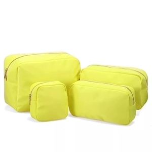 Set of 4 yellow nylon makeup bags in various sizes with waterproof zipper design