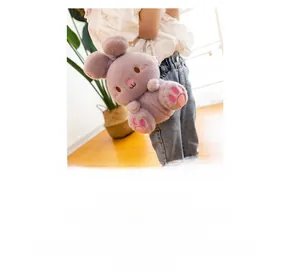 Detail view of a purple plush rabbit crossbody bag for children on a white sweater