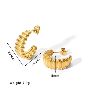 Detailed view of ribbed gold C-shaped earrings with 22mm size and 7.9g weight specs