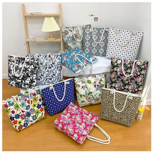 Collection of printed canvas tote bags with rope handles in various patterns and colors