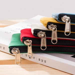 Minimalist canvas coin purses in multiple colors shown with metal zippers and fabric texture