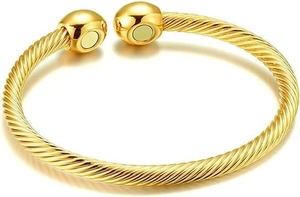 Detail of twisted cable gold bracelet with magnetic spherical ends on white background