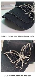 Detail of black satin baseball cap featuring large rhinestone butterfly and beaded brim