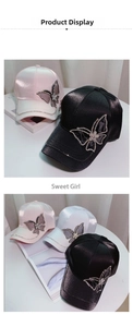 Detailed view of satin baseball hats with sparkling rhinestone butterfly appliques in three colors