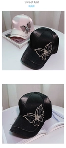 Detail of satin baseball cap featuring a large rhinestone butterfly and sparkling brim