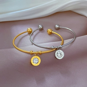 Minimalist titanium steel bangles in gold and silver with Roman numeral engraved charms