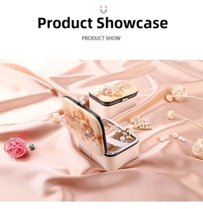 Detail view of portable jewelry boxes with interior compartments and floral art design