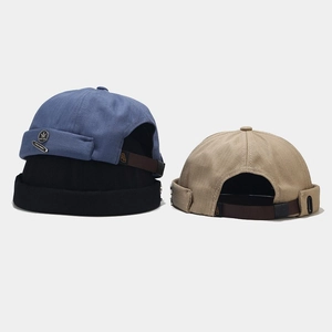 Vintage canvas docker miki hats in blue, black, and khaki with leather back straps