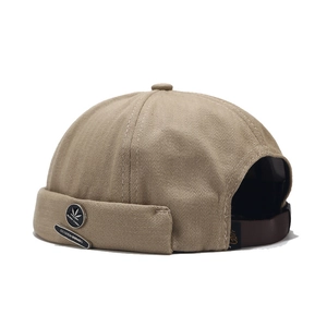 Khaki docker brimless hat with herringbone texture and premium metal badge detailing