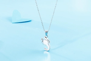 Detail shot of a silver stainless steel scorpion pendant with a thin chain necklace