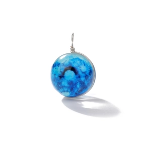 Close-up of a blue galaxy glass ball pendant with silver wire-wrapped loop detail