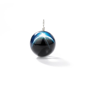 Macro detail of a spherical galaxy glass pendant with blue nebula and silver wire wrap