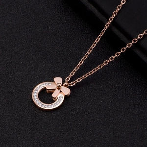 Rose gold necklace with circular bow pendant encrusted with sparkling rhinestones