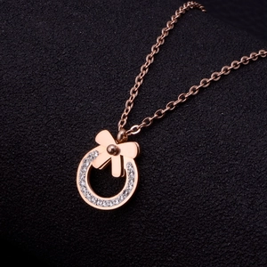 Rose gold bow and circle pendant necklace with sparkling crystals in high-end design