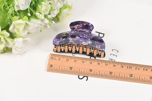 Detail view of purple marble floral hair claw with gold metal clip and size ruler