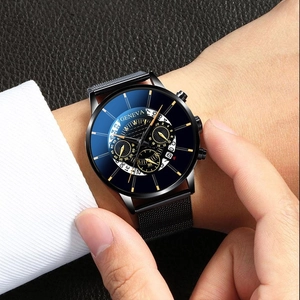 Macro detail of Geneva men's watch with black mesh strap and date display on leather