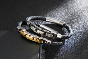 Close-up of woven leather bracelets featuring polished metal links and magnetic clasps