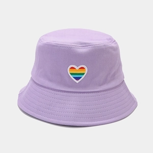 Close-up of rainbow heart embroidery on lavender cotton twill bucket hat texture