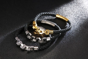 Detailed view of woven leather bracelets with gold, silver, and vintage metal clasps