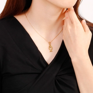Minimalist gold Ichthys fish pendant necklace for women shown on a model neck
