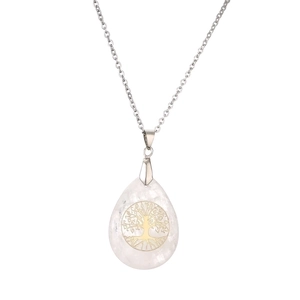Macro shot of silver tree of life pendant featuring translucent crystal waterdrop detail
