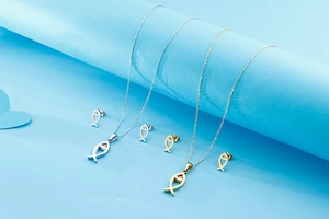 Detailed view of sweet fish-shaped necklace and stud earring sets in gold and silver