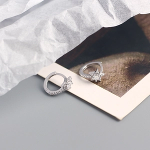 Close-up of S925 sterling silver star hoop earrings with sparkling cubic zirconia