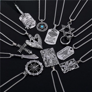 Macro view of vintage silver titanium pendants including cross and star designs