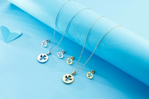 Macro view of gold and silver hollow angel necklace and earrings jewelry set
