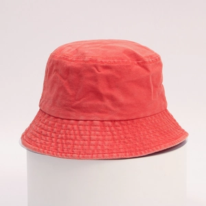 Red washed cotton bucket hat displayed on a white pedestal for outdoor sun protection