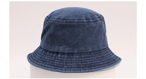 Macro detail of the washed navy denim bucket hat showing fabric texture and stitching