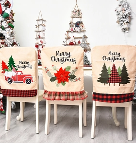 Detailed Christmas linen chair covers with red plaid trim and festive truck embroidery
