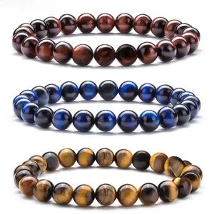 Close-up of red, blue, and yellow tiger eye stone beaded bracelets on white background