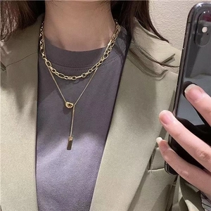 Double-layer gold titanium steel lucky bean necklace with long bar pendant for women